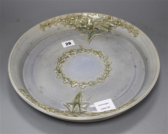 A Studio pottery tray, decorated with ivy leaves, seal mark to rim JC, diameter 35cm